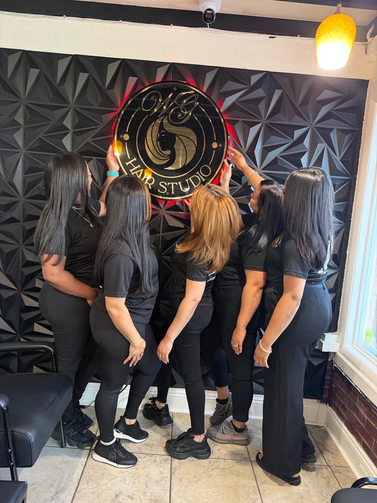 WG Hair Studio team at the salon sign